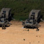 Israeli soldiers stand near the Israel-Lebanon border