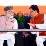 Prime Minister Narendra Modi (L) and Chief Minister Pushkar Singh Dhami