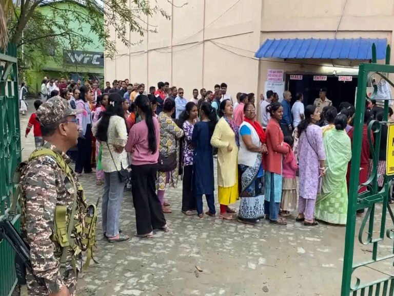 Voters line up at a polling booth in Dibrugarh
